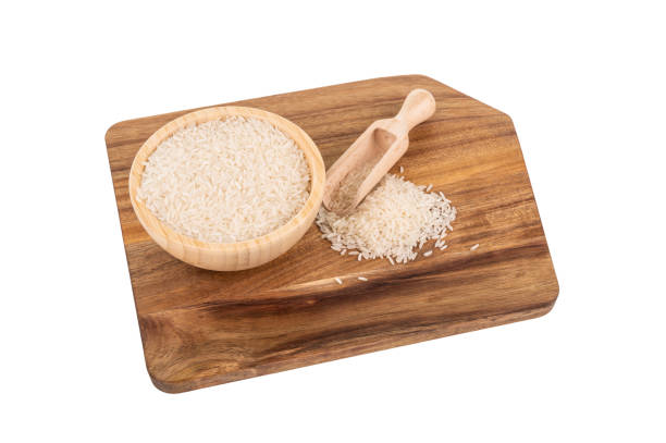 istock Jasmine rice in a wooden bowl with a scoop on a rustic cutting board 2190396150