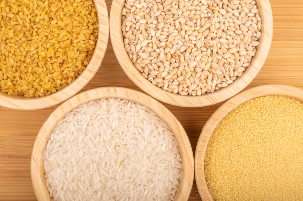 istock Assorted grains in wooden bowls on a bamboo surface 2190396179