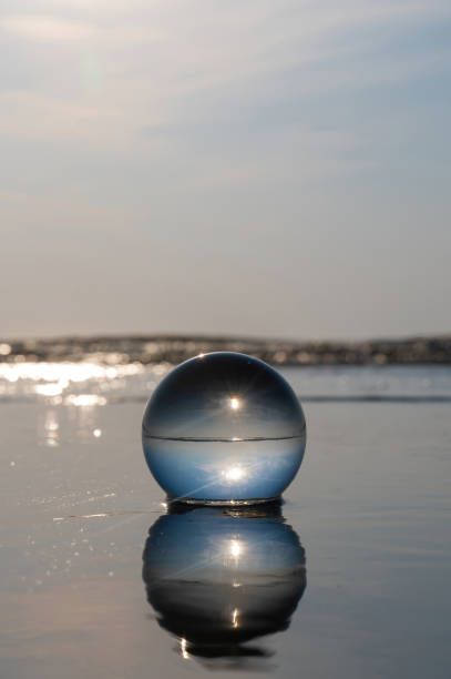 istock Water  and sea reflected in a ball lying in the waves 2190396535