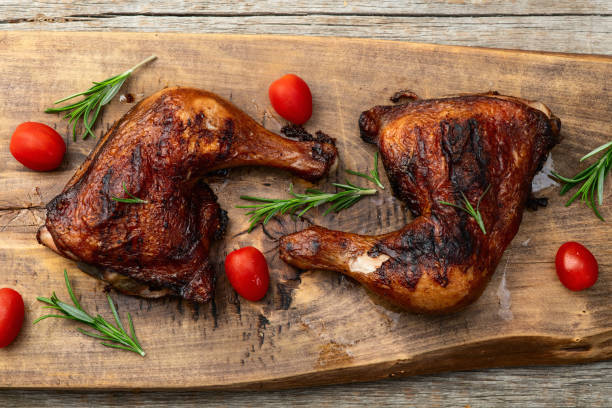 istock Grilled chicken legs with tomatoes and salad . Top view 2190396893