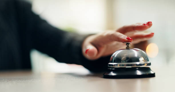 Hotel, bell and woman hands at reception with attention for customer support and concierge help. Hospitality, check in and lobby with front desk, service and counter with alert for registration