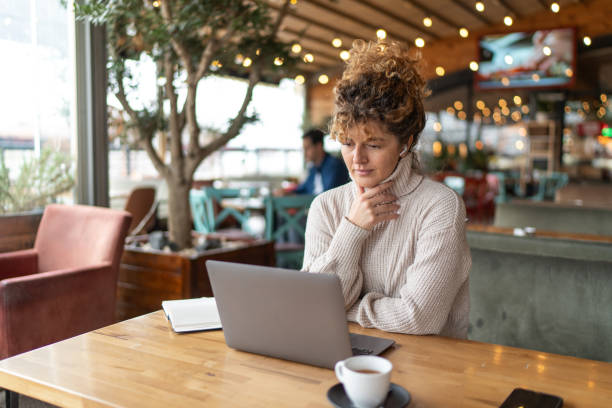 istock Young woman using laptop in cafe 2190397964