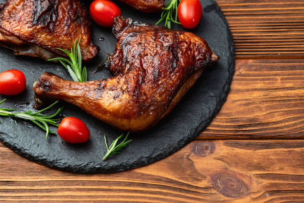 istock Grilled chicken legs with tomatoes and salad . Top view 2190398111