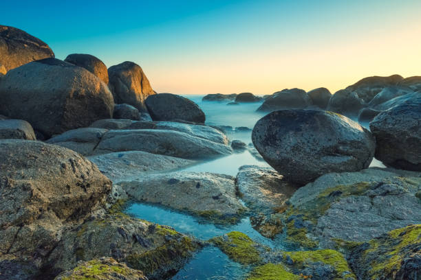 istock Ocean water flowing on rocks at sunset in canidelo beach 2190401359