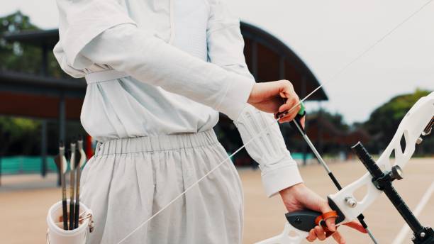 Hands, ready and bow for training, archery and preparing for competition, equipment and outdoor for game. Contest, athlete and practice from tournament, skills and challenge for person