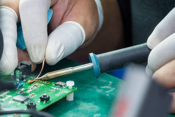 Close up scene the soldering operation by skill operator with rubber finger cot.