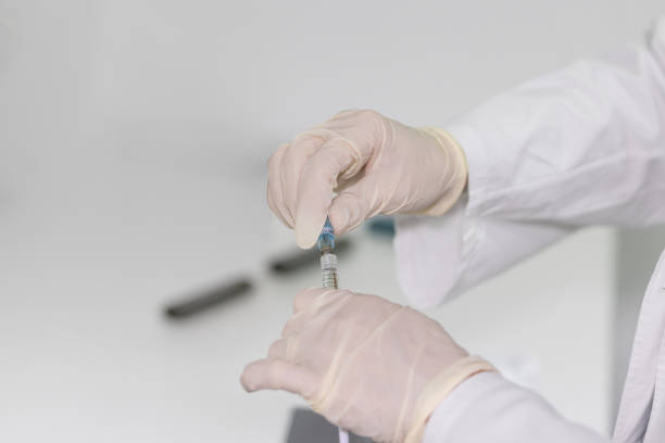istock Close-up of gloved hands preparing a syringe, with a focus on precision and sterility in a medical or clinical environment 2190404436