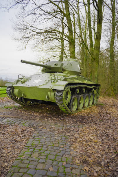 Restored Vintage Military Tank Displayed in a Woodland Setting