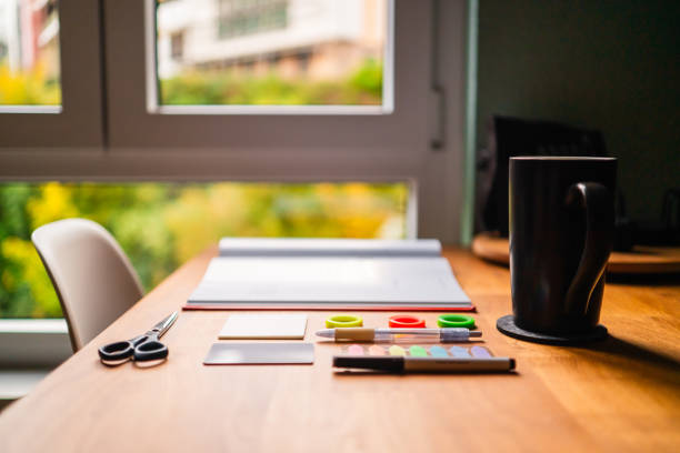istock Organized Home Workspace Table with Supplies and Window View 2190406254