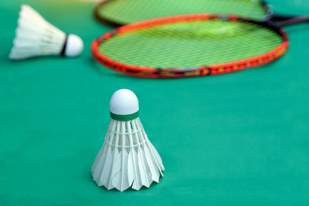 istock white shuttlecock on green background, blurred badminton racket and white shuttlecocks background. soft and selective focus 2190410291