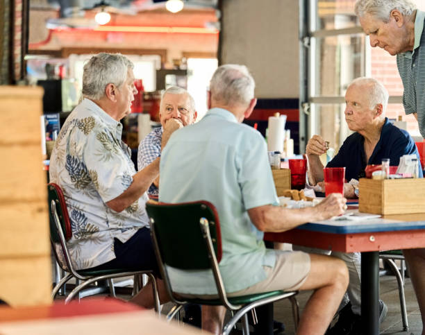 istock Group of senior friends sitting at restaurant table 2190410689