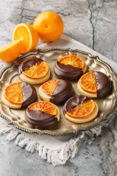 istock Shortbread cookies with caramelized orange covered with chocolate glaze close-up in a plate. Vertical 2190416471