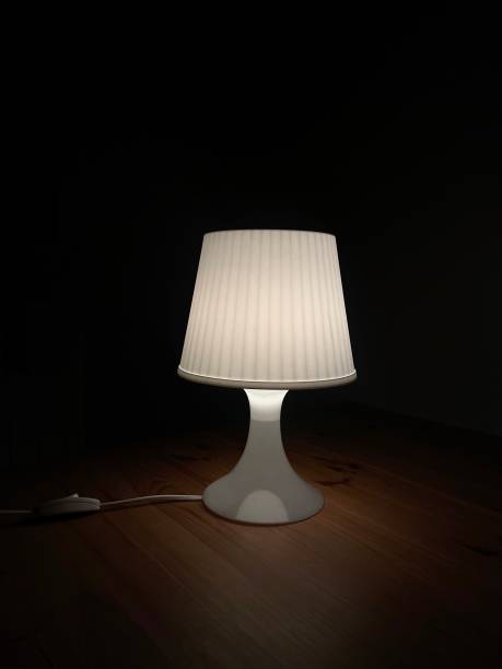 istock Modern Table Lamp Illuminating a Wooden Surface 2190425196