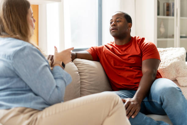 istock Multiracial couple talking, looking each other, enjoying resting at home 2190426321