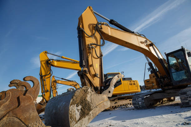 istock Multiple excavators operating on a construction site in winter conditions. 2190427302