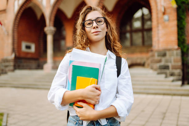 istock Student woman outdoors with bag and books near University. 2190428343