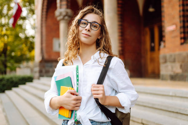 istock Student woman outdoors with bag and books near University. 2190428355