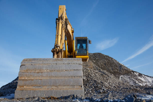 istock Excavator Shovel at Construction Site on Gravel Pile Front View Close-up 2190430377