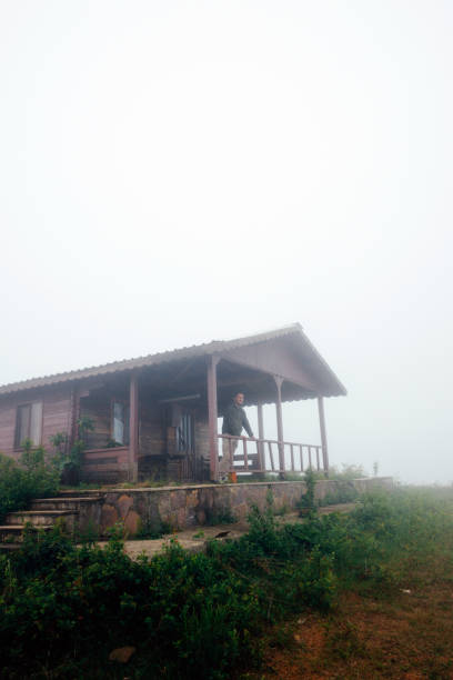 istock Man and Nature: A Serene Moment at a Hilltop Cabin 2190430638