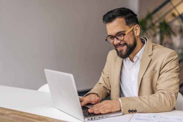 istock Successful businessman in modern office working on laptop 2190431125