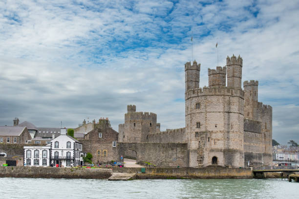 Caernarfon, UK-9 June 2024; Medieval fortress Caernarfon Castle a motte-and-bailey castle from 11th century which King Edward I of England began to replace with the current stone structure in 1283