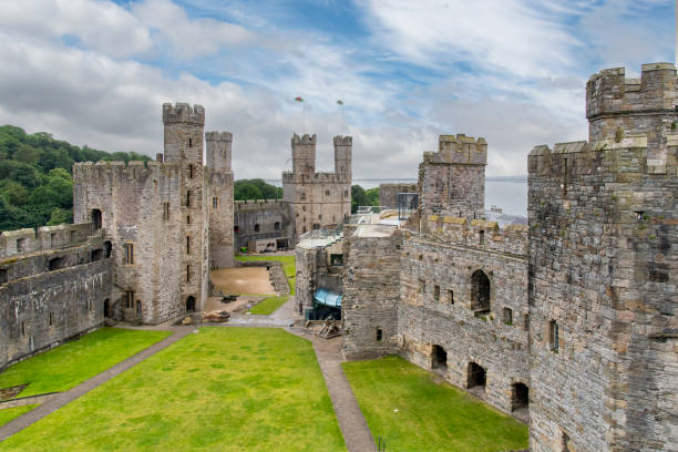 Caernarfon, UK-9 June 2024; Medieval fortress Caernarfon Castle a motte-and-bailey castle from 11th century which King Edward I of England began to replace with the current stone structure in 1283