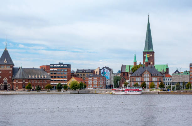 Buildings beside and near to the harbour in Aarhus, a port city in eastern Jutland, mainland Denmark. The old custom house (Toldboden) is on the left and the city’s cathedral (Aarhus Domkirke) to the right.