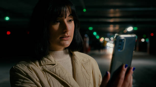 istock Woman at parking lot with mobile phone webcam talk has video call chat distant virtual meeting with friends colleague online conference remote communicating discussion with smartphone calling smiling 2190432287