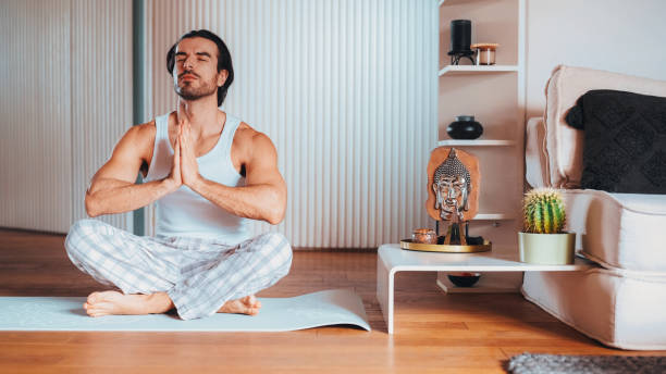 istock Man exercising yoga asanas at home 2190433847