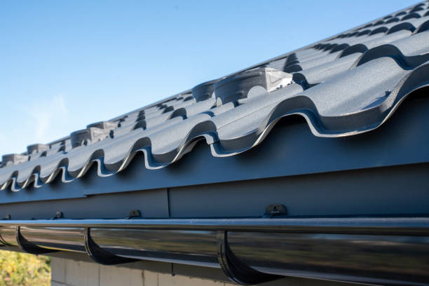 istock Gray plastic gutter system on roof overhang close up 2190435218