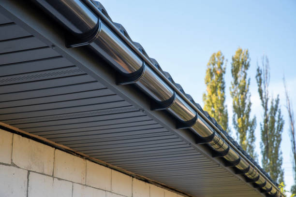 istock Gray plastic gutter system on roof overhang close up 2190435221