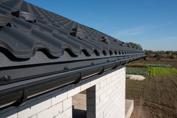 istock Gray plastic gutter system on metal roof overhang 2190435225