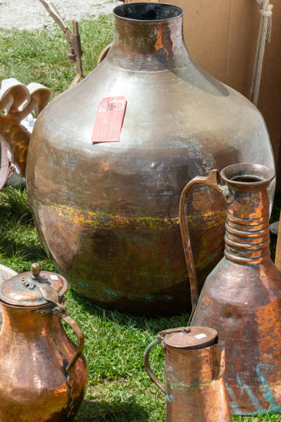 Brass and Copper items on display for sale at The Brimfield Antique Flea Market in a dealers space/ booth