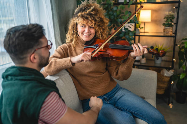 istock boyfriend teach girlfriend how to play violin practice at home 2190437496