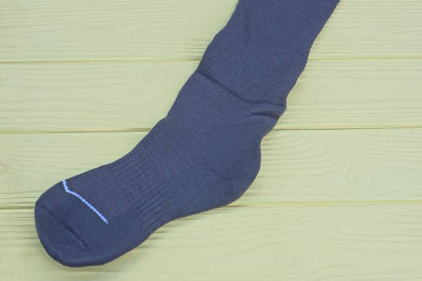 istock long fabric sock lies on a yellow wooden table 2190437505