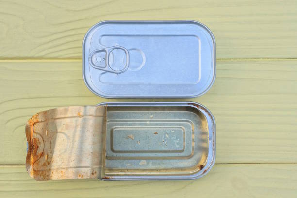 istock gray metal tin cans stand on yellow wooden table 2190437764