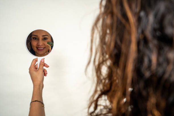istock Woman reflecting in small handheld mirror 2190439280