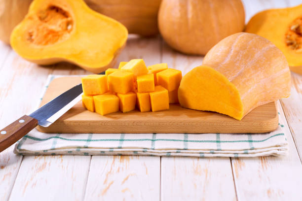 istock Diced butternut squash on wooden cutting board, selective focus. 2190441346