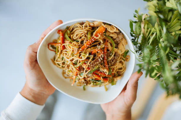 istock Radiant Asian Waitress Serving Gourmet Meal 2190441358