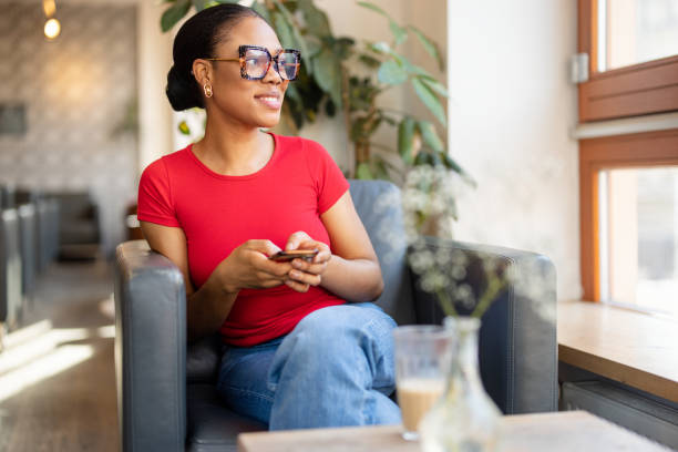 istock Happy Woman Holding Smartphone in a Cafe 2190441870