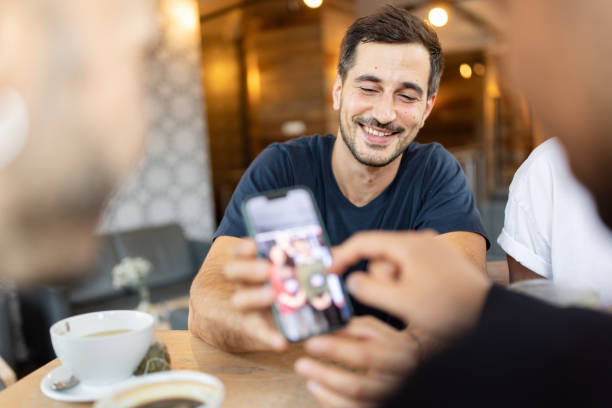 Man Sharing His Smartphone Screen with Friends
