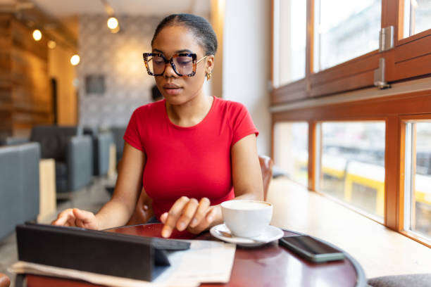 Woman in Red Shirt Relaxing and Using Tablet