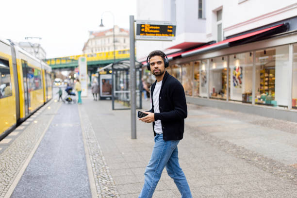 istock Man Crossing Tram Stop with Headphones in Berlin 2190441963