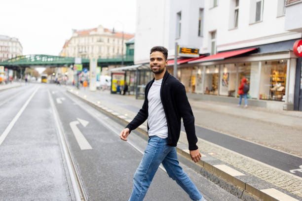 istock Young hispanic man crossing the road 2190441967