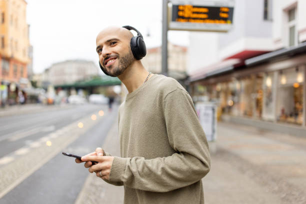 istock Bald Man Listening to Music with Smartphone in Berlin 2190441987