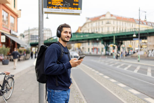 istock Man with Headphones Waiting at Berlin Tram Station 2190442004