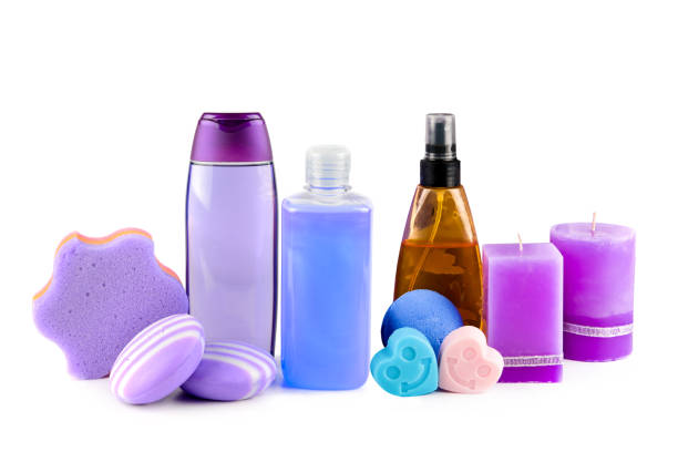 Lavender scented candles, shampoos and soaps with lavender extract isolated on white background.