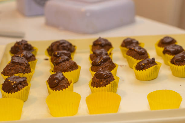 Tiny little chocolate balls. Homemade cakes, preparing holiday. Making cakes, work in progress