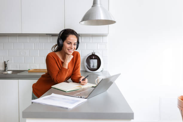 A woman focused on completing work assignments at home