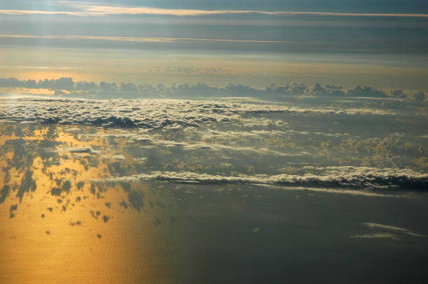 aerial view of dawn cloud and ocean reflecting sunlight